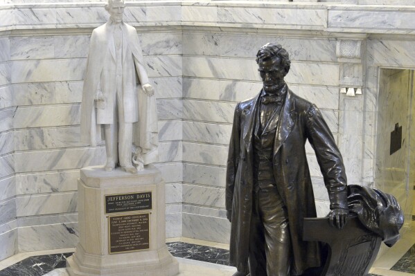 FILE - A statue of Jefferson Davis, left, looks towards a statue of Abraham Lincoln in the Rotunda of the Kentucky State Capitol in Frankfort, Ky., Aug. 5, 2015. Kentucky lawmakers would claim authority over what statues are installed or removed from the state Capitol's Rotunda under a bill passed Friday, March 1, 2024, by the GOP-led House, a move the bill sponsor said has nothing to do with the removal of a statue of Confederate President Jefferson Davis. (AP Photo/Timothy D. Easley, File)