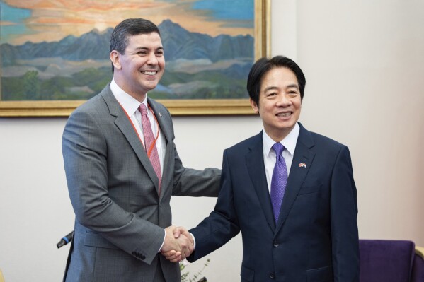 In this photo released by the Taiwan Presidential Office, Paraguay's president-elect Santiago Pena, left, shakes hands with Taiwan's Vice President in William Lai in Taipei, Taiwan, Wednesday, July 12, 2023. (Taiwan Presidential Office via AP)