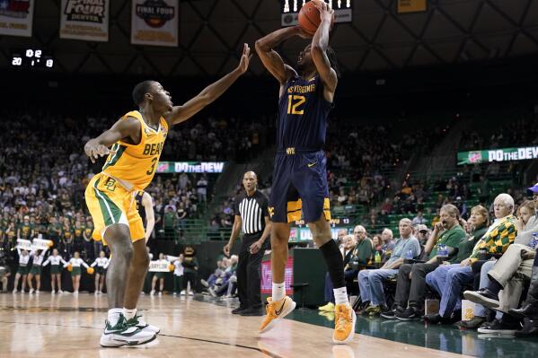Baylor guard Dale Bonner (3) defends against a three-point basket attempt by West Virginia guard Taz Sherman (12) in the first half of an NCAA college basketball game in Waco, Texas, Monday, Jan. 31, 2022. (AP Photo/Tony Gutierrez)