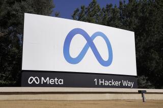 FILE - Facebook's Meta logo sign is seen at the company headquarters in Menlo Park, Calif. on Oct. 28, 2021. Meta said Thursday, June 1, 2023 is prepared to block access to news content for some Canadians on Facebook and Instagram as part of a temporary test that is expected to last through the end of June.(AP Photo/Tony Avelar, File)