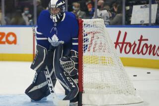 Toronto Maple Leafs goaltender Alexander Bishop warms up before an NHL hockey game against the Ottawa Senators in Toronto, Saturday, Oct. 16, 2021. The Maple Leafs signed the University of Toronto player to a one-day amateur tryout as a backup goaltender. (Evan Buhler/The Canadian Press via AP)
