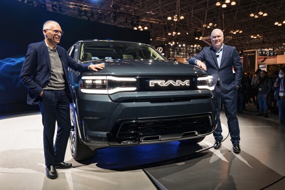 File - Carlos Tavares, Chief Executive Officer of Stellantis, left, and Mike Koval, RAM Brand Chief Executive Officer, introduces the REV Ram 1500 at the New York International Auto Show in New York on April 5, 2023. United Auto Workers President Shawn Fain's focus on CEO pay is part of a growing trend as emboldened labor unions cite the widening wealth gap between workers and the top bosses to bolster their demand for higher wages and better working conditions. (AP Photo/Craig Ruttle, File)