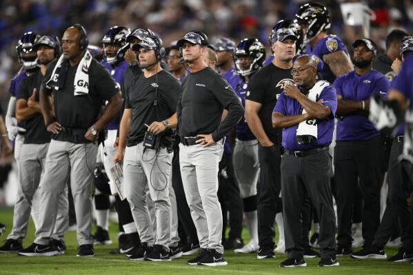 Baltimore Ravens head coach John Harbaugh, center, stands on the sideline in the first half of a preseason NFL football game against the Washington Commanders, Saturday, Aug. 27, 2022, in Baltimore. (AP Photo/Nick Wass)