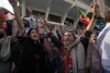 Former Prime Minister Imran Khan and supporters of political party Pakistan Tehreek-e-Insaf (PTI) attend an election campaign rally in Karachi, Pakistan, Sunday, Jan. 28, 2024.  Pakistani police fired tear gas to disperse supporters of former Prime Minister Imran.  Khan was in the southern city of Karachi on Sunday, less than two weeks before national parliamentary elections where Khan is barred from contesting due to a criminal conviction.  (AP Photo/Farid Khan)