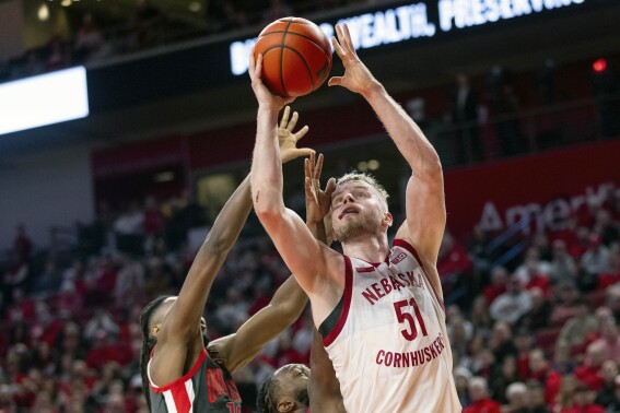 FILE - Nebraska's Rienk Mast (51) goes for two points past Ohio State's Evan Mahaffey (12) and Bruce Thornton (2) during an NCAA college basketball game, Tuesday, Jan. 23, 2024 in Lincoln, Neb. Nebraska forward Rienk Mast will have surgery on his left knee and miss the 2024-25 season, coach Fred Hoiberg said Thursday, May 2, 2024. Mast, who averaged 12.3 points and 7.5 rebounds per game, said he plans to take a medical redshirt and return in 2025-26.(Anna Reed/Omaha World-Herald via AP, File)