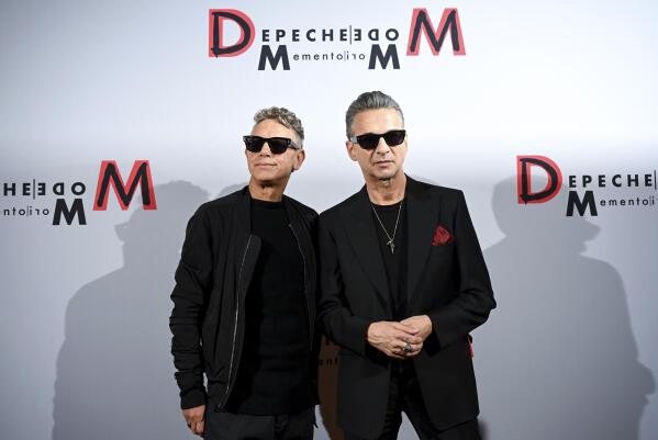 Musicians Martin Gore, left, and Dave Gahan of the British band Depeche Mode stand in front of a photo wall during a photo session in Berlin, Germany, Tuesday, Oct. 4, 2022. (Britta Pedersen/dpa via AP)