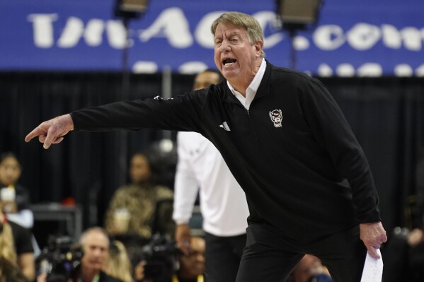 NC State head coach Wes Moore directs his team against Notre Dame during the first half of an NCAA basketball game for the Women's Atlantic Coast Conference championship in Greensboro, N.C., Sunday, March 10, 2024. (AP Photo/Chuck Burton)