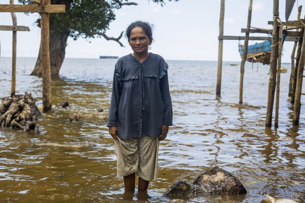 Nina, 33, a member of Bajau Tribe, poses for a photograph on Kabaena Island, Indonesia, Friday, Nov. 15, 2024. (AP Photo/Yusuf Wahil)