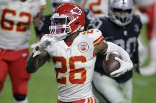 FILE - In this Nov. 22, 2020, file photo, Kansas City Chiefs running back Le'Veon Bell (26) carries the ball against the Las Vegas Raiders during the first half of an NFL football game in Las Vegas. The Baltimore Ravens signed Bell to their practice squad, adding another backfield option in the aftermath of J.K. Dobbins’ season-ending injury. Bell was cut early last season by the New York Jets, then rushed for 328 yards in 11 games with Kansas City. He did not play in the Super Bowl for the Chiefs. (AP Photo/Isaac Brekken, File)