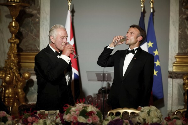 French President Emmanuel Macron, right, and Britain's King Charles III toast during a state dinner in the Hall of Mirrors at the Chateau de Versailles in Versailles, west of Paris, Wednesday, Sept. 20, 2023. President Emmanuel Macron and King Charles III held talks in Paris on Wednesday at the start of a long-awaited three-day state visit meant to highlight the friendship between France and the U.K. (Benoit Tessier/Pool via AP)