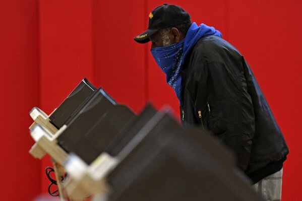 Robert Powell casts his ballot at Alliance High School, Tuesday, Nov. 3, 2020, in Alliance, Ohio. (AP Photo/David Dermer)