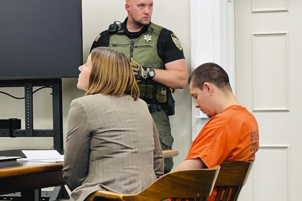 Majorjon Kaylor, 31, right, sits next to defense attorney Lisa Chesebro in a Wallace, Idaho, courtroom on Tuesday, June 20, 2023, during his first appearance on four murder charges. Prosecutors say Kaylor shot and killed his neighbors, including a child, Sunday evening. Idaho State Police have released few details, but said the shooting occurred after a "dispute between neighbors." (Josh McDonald/Shoshone News-Press via AP)