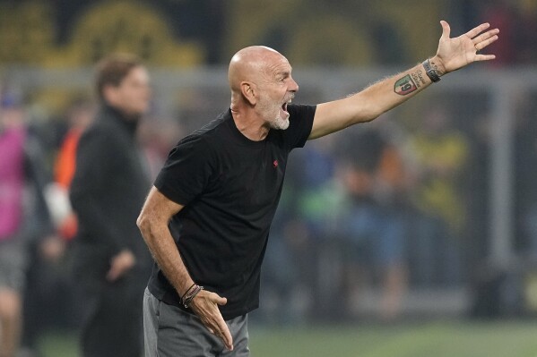 AC Milan's manager Stefano Pioli shouts out as gives instructions from the side line during the Champions League Group F soccer match between Borussia Dortmund and AC Milan at the Signal Iduna Park Stadium in Dortmund, Germany, Wednesday, Oct. 4, 2023. (AP Photo/Martin Meissner)