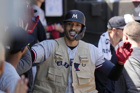 Minnesota Twins' Carlos Correa celebrates with teammates after hitting a solo home run during the sixth inning of a baseball game against the Chicago White Sox in Chicago, Thursday, May 4, 2023. (AP Photo/Nam Y. Huh)
