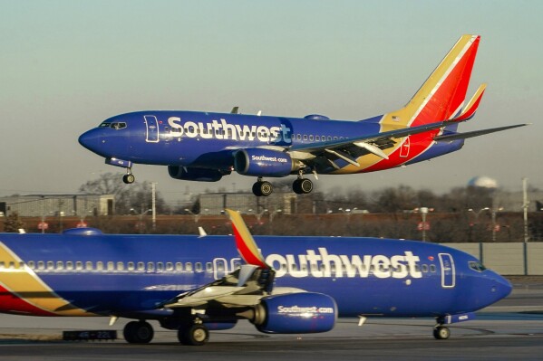 FILE - Southwest Airlines plane prepares to land at Midway International Airport, Feb. 12, 2023, in Chicago. Southwest Airlines is back in court over firing a flight attendant with anti-abortion views. (AP Photo/Kiichiro Sato, File)