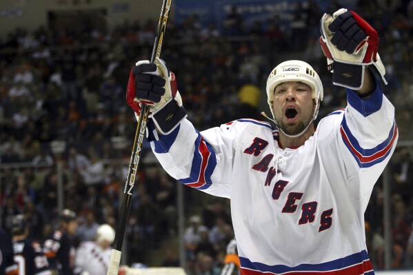 FILE - New York Rangers' Chris Simon celebrates his second-period goal against the New York Islanders, Thursday, Feb. 26, 2004, at Nassau Coliseum in Uniondale, N.Y. Former NHL enforcer Chris Simon has died. He was 52. Simon died Monday night, March 18, 2024, according to a spokesperson for the NHL Players' Association. (AP Photo/Ed Betz, File)