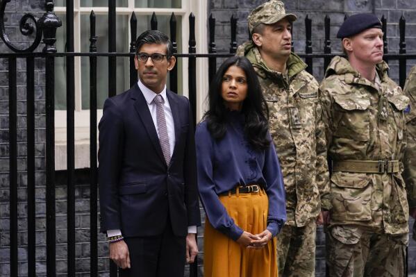 FILE - Britain's Prime Minister Rishi Sunak and his wife Akshata Murthy joined outside 10 Downing Street by Ukrainian Ambassador to the UK, Vadym Prystaiko and his wife Inna (not pictured) and members of the Ukrainian Armed Forces and representatives from each Interflex nation, during a minute's silence to mark the one-year anniversary of the full-scale Russian invasion of Ukraine, in London, on Feb. 24, 2023. Sunak is under investigation over allegations he failed to disclose shares his wife owns in a child care business that stands to benefit from his government's budget, a parliamentary watchdog disclosed. (AP Photo/Alberto Pezzali, File)