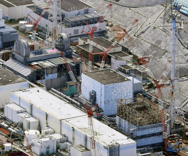 FILE - This Sept. 4, 2017, aerial file photo shows Fukushima Dai-ichi nuclear power plant reactors, from bottom at right, Unit 1, Unit 2 and Unit 3, in Okuma town, Fukushima prefecture, northeastern Japan. Its operator Tokyo Electric Power Company (TEPCO) says both of two seismometers at Unit 3, one of three melted reactors, had been out of order since last week and were not able to collect data when a powerful earthquake struck the area on Feb. 13, 2021, calling into question if the company's risk management has improved since the disaster. (Daisuke Suzuki/Kyodo News via AP, File)