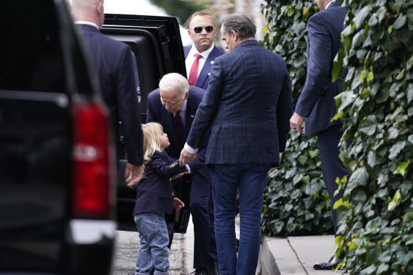 President Joe Biden, center, talks to his grandson Beau, left, as son Hunter Biden, right, looks on after dining at The Ivy in Los Angeles, Sunday, Feb. 4, 2024. Today is Hunter Biden's birthday. (APPhoto/Stephanie Scarbrough)