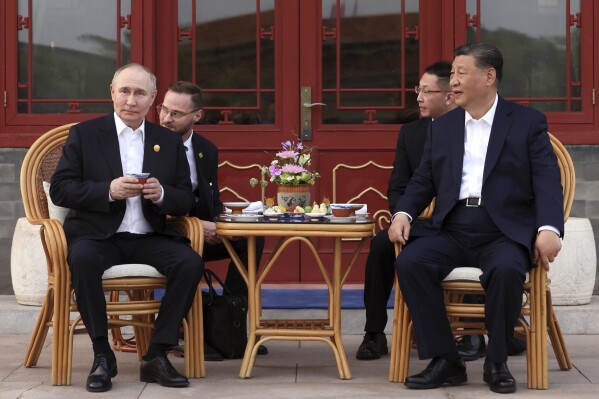 Russian President Vladimir Putin, left, and Chinese President Xi Jinping attend an informal meeting in Beijing, China, on Thursday, May 16, 2024. (Mikhail Metzel, Sputnik, Kremlin Pool Photo via AP)