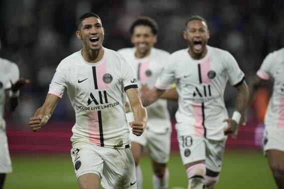 PSG's Achraf Hakimi, left, reacts after scoring his side's second goal during the French League One soccer match between FC Metz and Paris Saint-Germain at Saint Symphorien stadium, in Metz, eastern France, Wednesday, Sept. 22, 2021. (AP Photo/Christophe Ena)