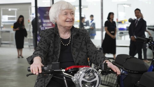 U.S. Treasury Secretary Janet Yellen sits on a scooter while visiting a factory assembling electric scooters in Hanoi, Vietnam on Thursday, July 20, 2023. The U.S. considers building strong economic and security ties with Vietnam a priority, Yellen said as she met with Vietnamese officials in a visit aimed at fortifying America's relations across Asia. (AP Photo/Hau Dinh)