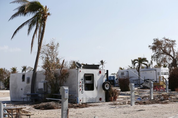In this Thursday, Sept. 21, 2017, photo, the remains of damaged and overturned trailers sit at the Sunshine Key RV Resort and Marina, in Big Pine Key, Fla. Monroe County is asking mobile home park owners to allow FEMA to set up temporary housing on their properties. (AP Photo/Wilfredo Lee, File)