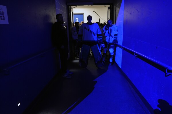 Professional Women's Hockey League New York players wait to enter the rink for the inaugural PWHL game in Toronto, Monday, Jan. 1, 2024. (AP Photo/Brittany Peterson)