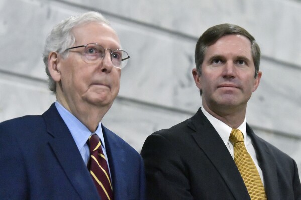 FILE - Senate Minority Leader Mitch McConnell, R-Ky., left, stands with Kentucky Gov. Andy Beshear, right, during a ceremony in the Rotunda at the Kentucky State Capitol in Frankfort, Ky., Jan. 2, 2024. Republican lawmakers Friday, April 12, 2024, removed any role for Kentucky's Democratic governor in filling a U.S. Senate seat if a vacancy occurred in the home state of Senate Republican leader McConnell. The GOP supermajority legislature easily overrode Beshear's veto of the measure. (AP Photo/Timothy D. Easley, File)