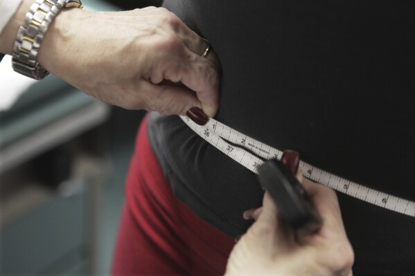 FILE - A waist is measured during an obesity prevention study in Chicago, Jan. 20, 2010. (AP Photo/M. Spencer Green, File)