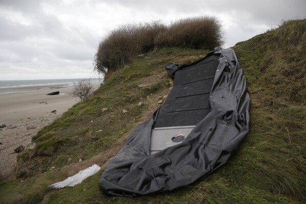 FILE - A damaged inflatable small boat is pictured on the shore in Wimereux, northern France, Thursday, Nov. 25, 2021 near Calais, northern France. A French report published Thursday Jan.4, 2024 said the UK is not sufficiently coordinating with France in efforts to reduce numbers of migrants crossing the English Channel in small boats, as part of a broader assessment pointing to the "uncertain effectiveness" of illegal migration policies. (AP Photo/Michel Spingler, File)