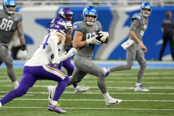 Detroit Lions tight end Sam LaPorta (87) is chased by Minnesota Vikings safety Camryn Bynum during the first half of an NFL football game, Sunday, Jan. 7, 2024, in Detroit. (AP Photo/Paul Sancya)