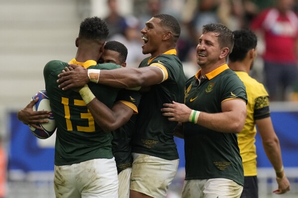 South Africa's Grant Williams, second left, celebrates with his teammates after scoring a try during the Rugby World Cup Pool B match between South Africa and Romania at the Stade de Bordeaux in Bordeaux, France, Sunday, Sept. 17, 2023. (AP Photo/Themba Hadebe)