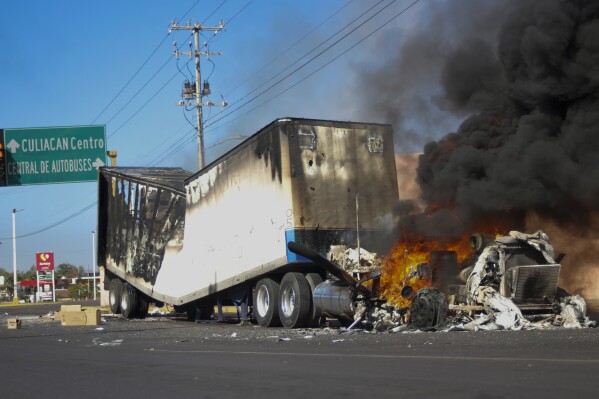 A truck burns on a street in Culiacan, Sinaloa state, Thursday, Jan. 5, 2023. (AP Photo/Martin Urista, file)