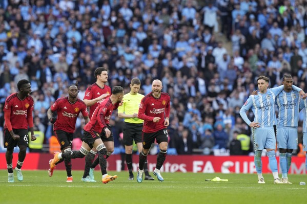 Manchester United players react during a penalty shootout at the end of the English FA Cup semifinal soccer match between Coventry City and Manchester United at Wembley stadium in London, Sunday, April 21, 2024. (AP Photo/Alastair Grant)