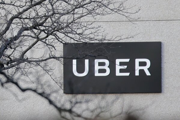 FILE - In this Nov. 15, 2019, file photo is an Uber office in Secaucus, N.J. Uber continued to lose cash as it poured money into building its food delivery business and developing technology for driverless cars, but revenue for its rides business nearly tripled as the company picked up more passengers around the world. 
The ride-hailing giant lost $1.1 billion in the fourth quarter of 2019, about 24% more than it lost at the same time last year. (AP Photo/Seth Wenig, File)
