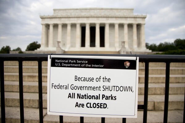 FILE - A sign reading "Because of the Federal Government SHUTDOWN All National Parks are Closed" is posted on a barricade in front of the Lincoln Memorial in Washington, Oct. 1, 2013. The federal government is heading toward a shutdown at month's end that will disrupt many services, squeeze workers and roil politics. It comes as Republicans in the House, fueled by hard-right demands for deep cuts, force a confrontation over federal spending. (AP Photo/Carolyn Kaster, File)
