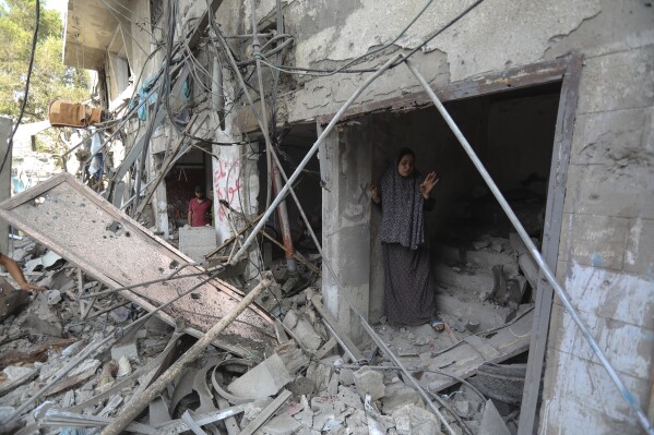 FILE - Palestinians inspect the damage of buildings that were hit by Israeli airstrikes, in the Shati refugee camp, Gaza City, Tuesday, Oct. 31, 2023. Israel's military offensive has turned much of northern Gaza into an uninhabitable moonscape. When the war ends, any relief will quickly be overshadowed by the dread of displaced families for their future. (AP Photo/Abed Khaled, File)