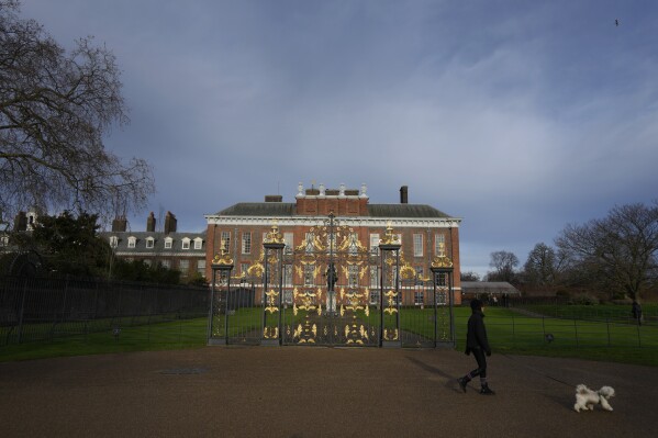 FILE - A dog walker passes Kensington Palace in London, Friday, Jan. 6, 2023. The first official photo of Kate, the Princess of Wales, since she underwent abdominal surgery nearly two months earlier, was pulled from circulation by The Associated Press and several other news organizations, Sunday, March 10, 2024, because the image appeared to have been manipulated. (AP Photo/Kirsty Wigglesworth, File)