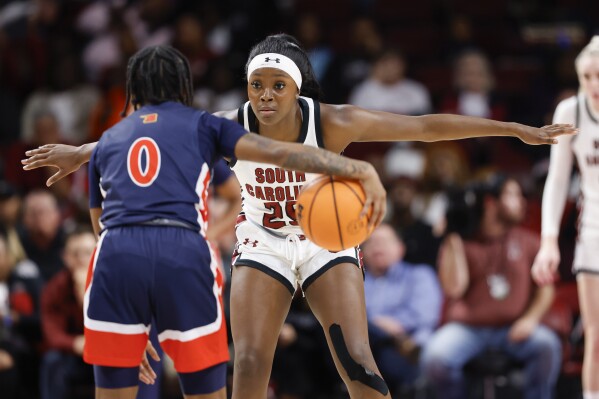 South Carolina guard Raven Johnson (25) defends against Morgan State guard Tamaria Rumph (0) during the second half of an NCAA college basketball game in Columbia, S.C., Wednesday, Dec. 6, 2023. (AP Photo/Nell Redmond)