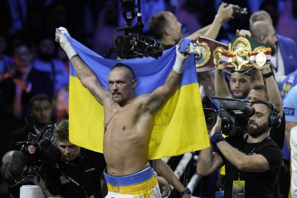 FILE - Ukraine's Oleksandr Usyk celebrates after beating Britain's Anthony Joshua to retain his world heavyweight title at King Abdullah Sports City in Jeddah, Saudi Arabia, Sunday, Aug. 21, 2022. Tyson Fury is only interested in fighting Oleksandr Usyk to become undisputed world heavyweight champion if he gets 70% of the earnings from the bout. (AP Photo/Hassan Ammar, File)