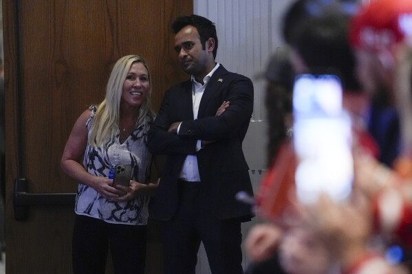 Rep. Marjorie Taylor Greene, R-Ga., talks with former Republican presidential candidate Vivek Ramaswamy as they wait for Republican presidential candidate former President Donald Trump to speak at a primary election night party in Nashua, N.H., Tuesday, Jan. 23, 2024. (AP Photo/Matt Rourke)