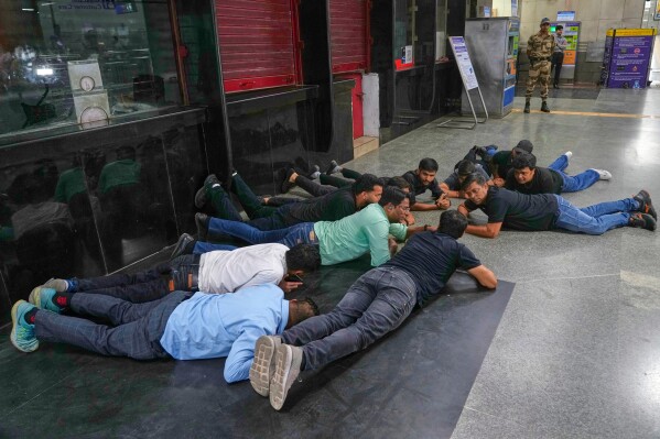 Civil defense members carry out a mock drill at a metro station to train civilians and security personnel to respond in case of attack, in New Delhi, India, Wednesday, May 7, 2025. (AP Photo/Manish Swarup)