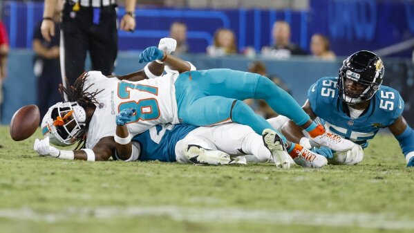Daewood Davis of Dolphins carted off field after collision; preseason game  vs. Jaguars halted