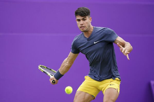 Spain's Carlos Alcaraz plays Argentina's Francisco Cerundolo during their men's singles match on day four of The Queen's Club tennis tournament, in London, Tuesday, June 18, 2024. (Zac Goodwin/PA via AP)