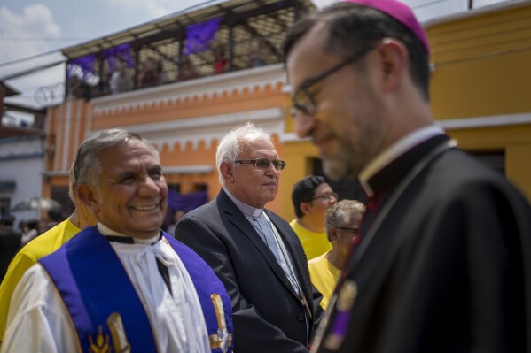 Cardinal Alvaro Ramazzini, center back, waits for the start of a religious procession, in Guatemala City, March 23, 2024. Elevated by Pope Francis in 2019 to the top hierarchy of the Catholic Church, Ramazzini has continued his focus on the poor, the Indigenous and the migrant. (AP Photo/Moises Castillo)