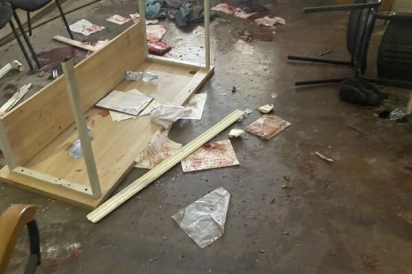 In this photo provided by the Ukrainian Police Press Office, blood is seen at the scene of an incident with exploded grenades, in Keretske, Zakarpattia region, Ukraine, Friday, Dec. 15, 2023. A village council member in western Ukraine detonated three hand grenades during a meeting Friday, critically injuring himself and at least two dozen other people, authorities said. (Ukrainian Police Press Office via AP)