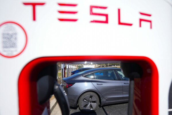 A Tesla level three Electric vehicle charger is visible, Feb. 2, 2024, in Kennesaw, Ga., near Atlanta. (AP Photo/Mike Stewart, File)