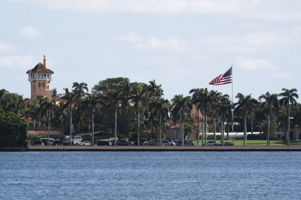 The U.S. flag is shown at the Mar-a-Lago compound in Palm Beach, Fla., while a U.S. Coast Guard boat patrols around the vicinity, Monday, Jan. 13, 2025. U.S. flags at President-elect Donald Trump's private Mar-a-Lago club are back to flying at full height. Flags are supposed to fly at half-staff through the end of January out of respect for former President Jimmy Carter, who died Dec. 29. (AP Photo/Manuel Balce Ceneta)