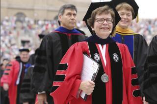 FILE - In this May 16, 2015 file photo, Chancellor Rebecca Blank, center, walks in a procession at the start of the University of Wisconsin-Madison spring commencement ceremony in Madison, Wis. Blank, chancellor of University of Wisconsin-Madison, Wisconsin's flagship campus, has been named the next president of Northwestern University, Northwestern's Board of Trustees announced Monday, Oct. 11, 2021. She will become Northwestern's 17th president, effective in the summer of 2022. (Amber Arnold/Wisconsin State Journal via AP, File)